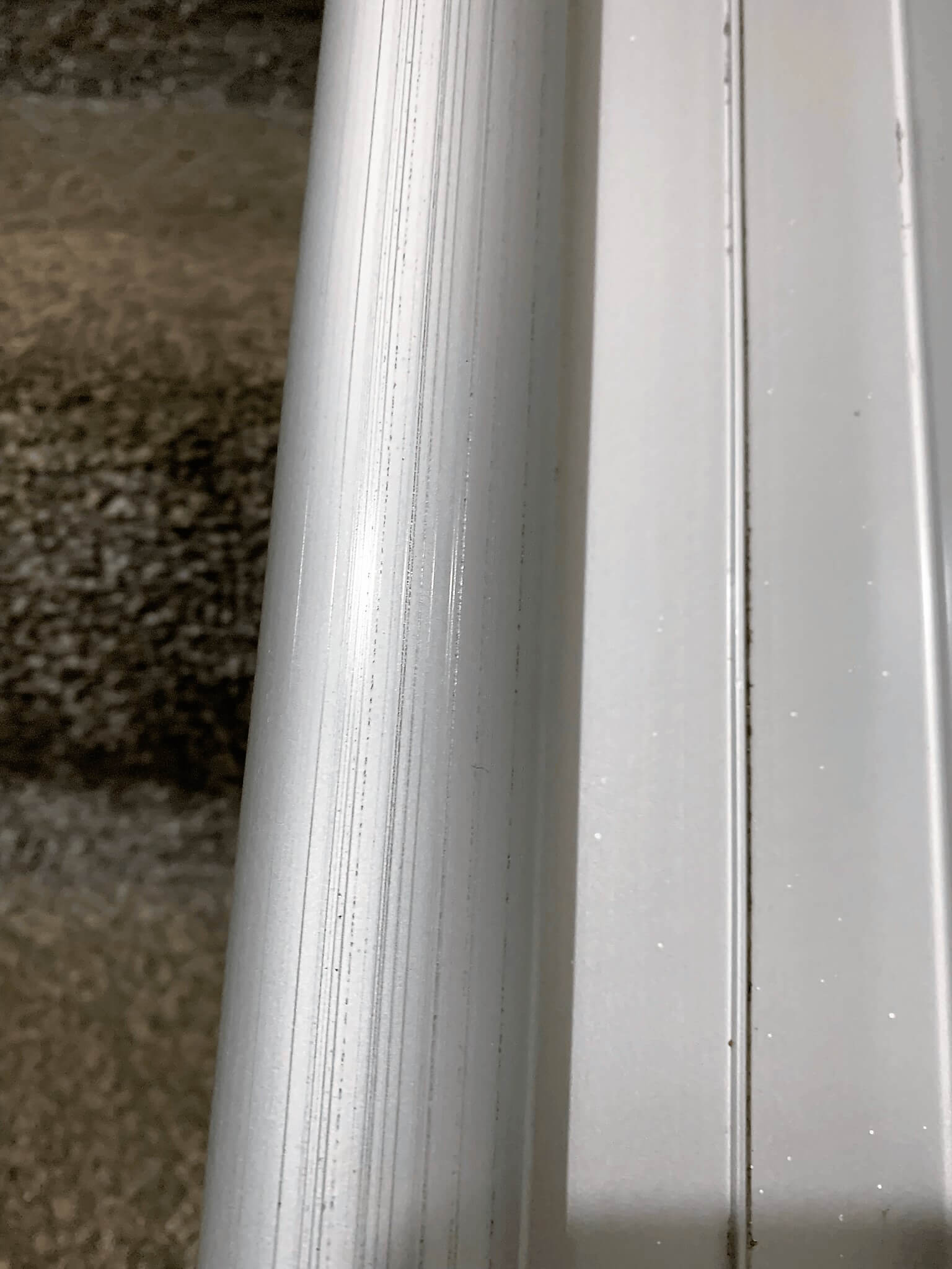 Wear marks on the running face of an Acorn straight stairlift rail caused by jammed rollers