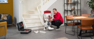 A skilled stairlift removal engineer carefully disassembling a stairlift, ensuring a smooth and efficient process for reclaiming space and facilitating accessibility improvements